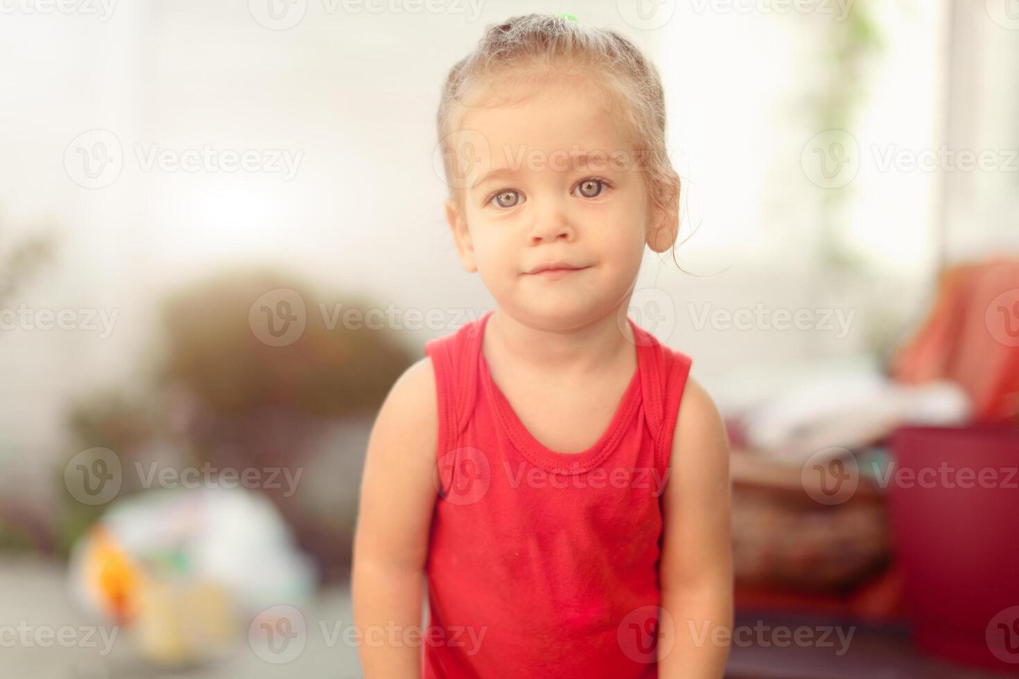 Portrait of blonde girl with blue eyes in the park. Child, baby girl close up smile photo