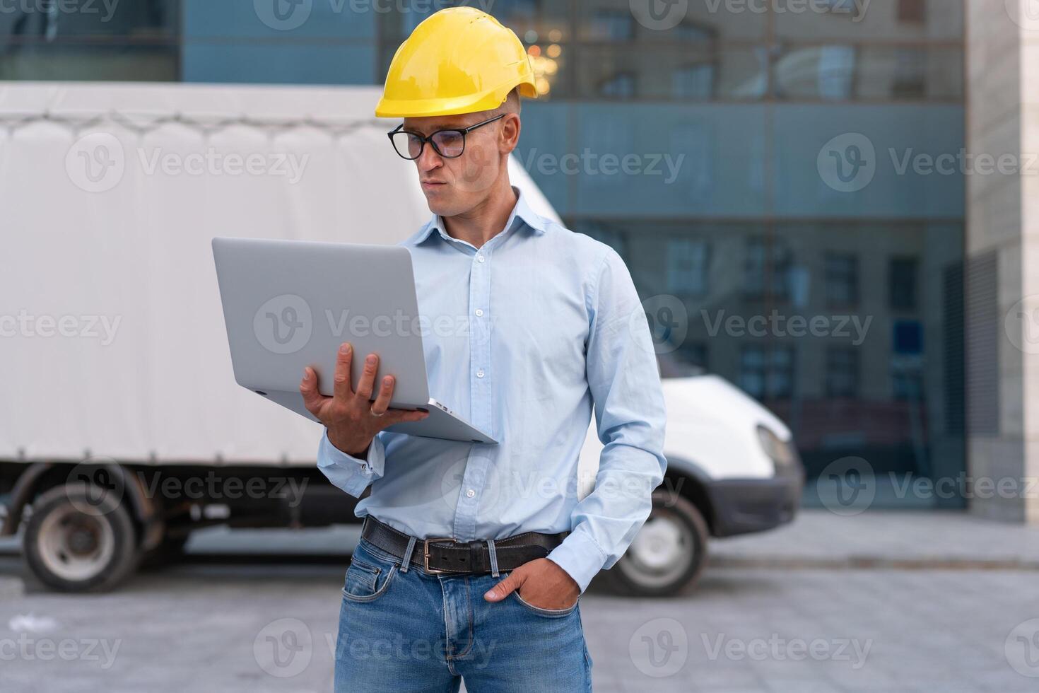 Business. Engineer Worker Protective Helmet Use Laptop Controls Working Process Inspector Supervisor Yellow Hard Hat Glasses Transportation Company photo