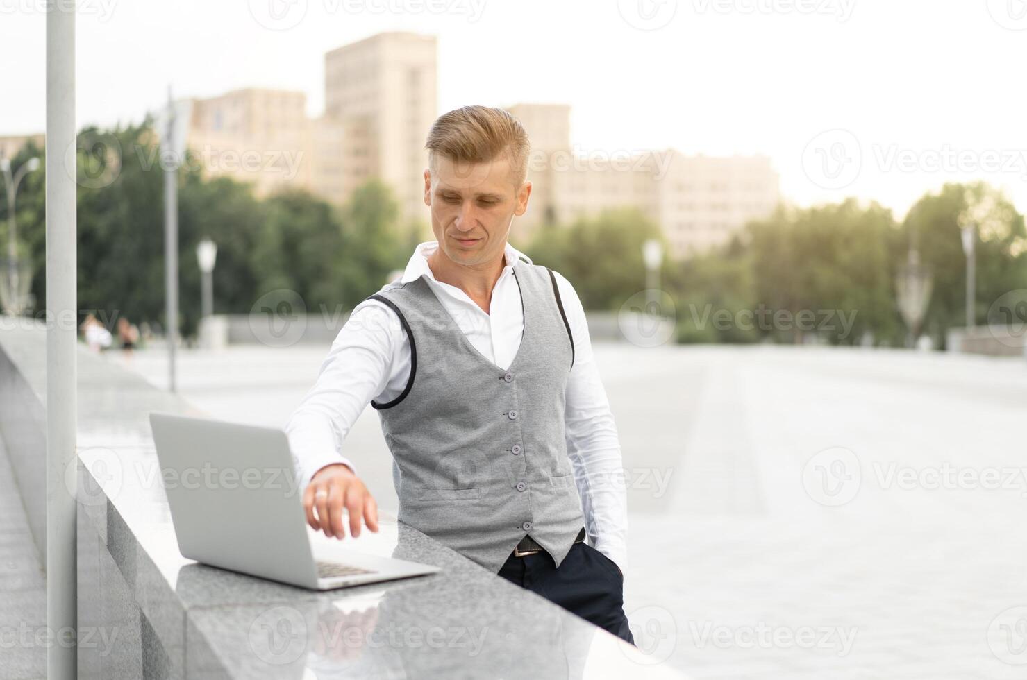 Business. Businessman Using Laptop Outdoors. Modern Technology Concept photo
