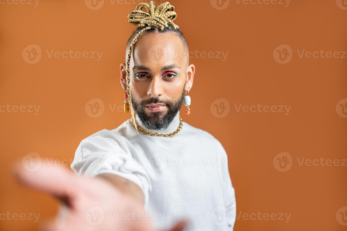 Black latin gay man outstretching empty hand towards camera photo
