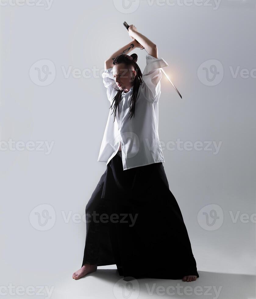 Young man holding a samurai sword. Glamour photo. photo