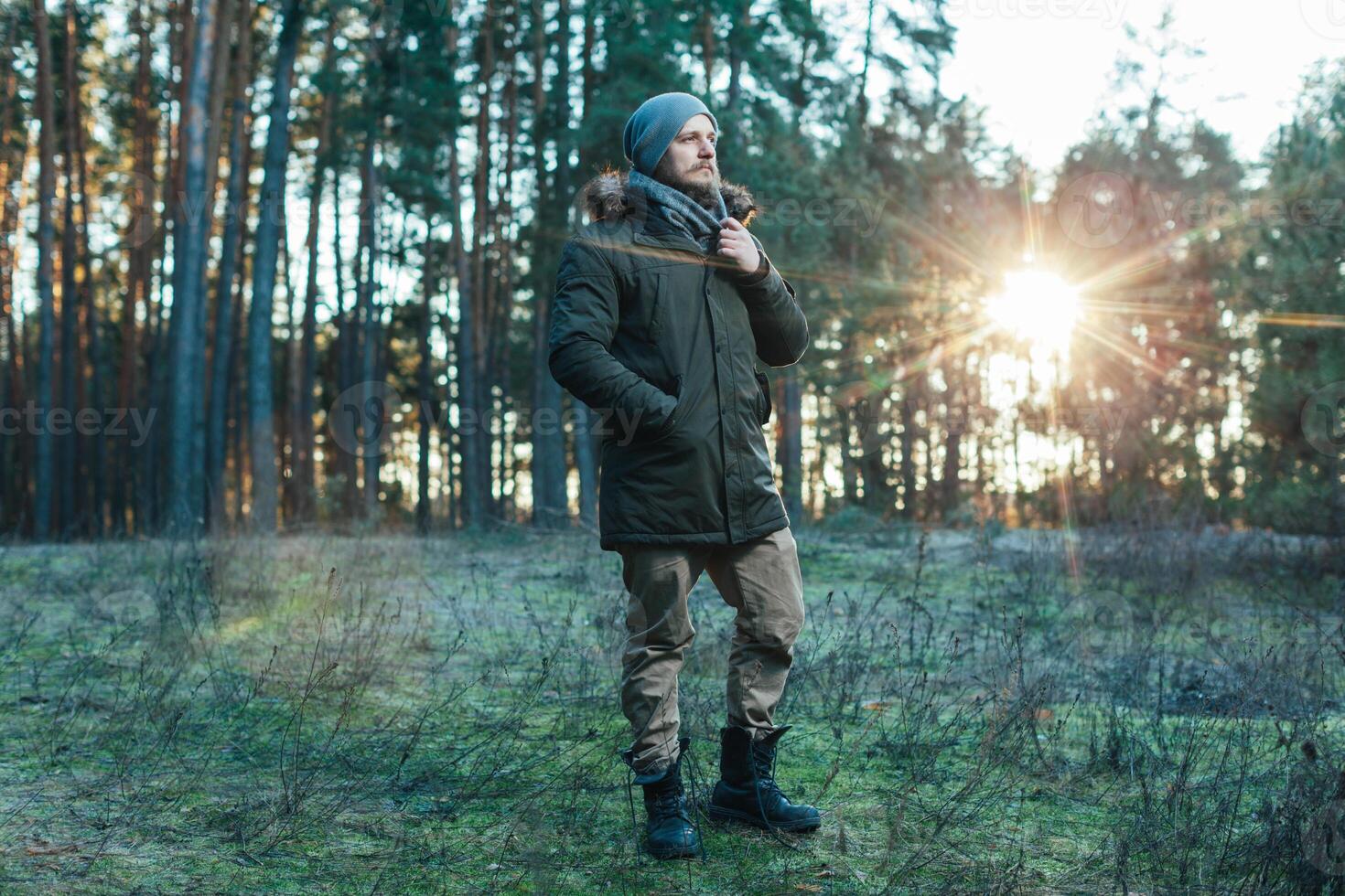 Portrait brutal bearded hipster man in the forest photo