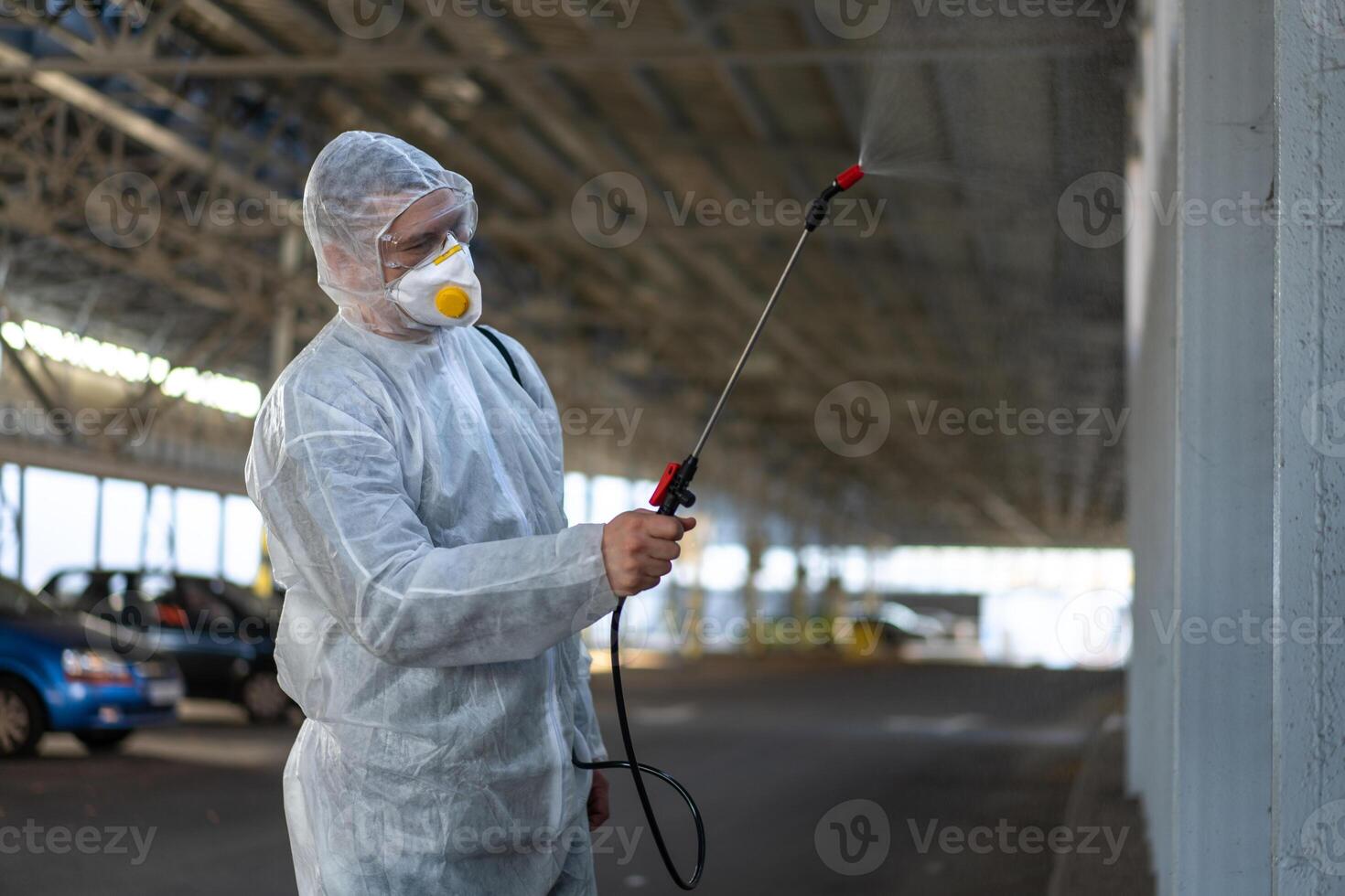 Worker wearing protective suit disinfection gear disinfect surface public place photo