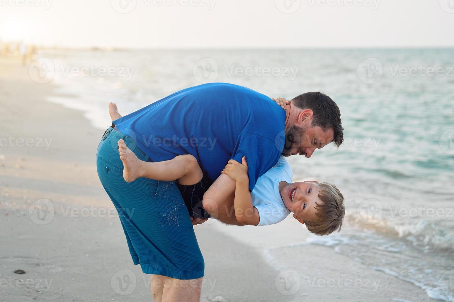 Father son spending time together sea vacation Young dad child little boy walking beach photo