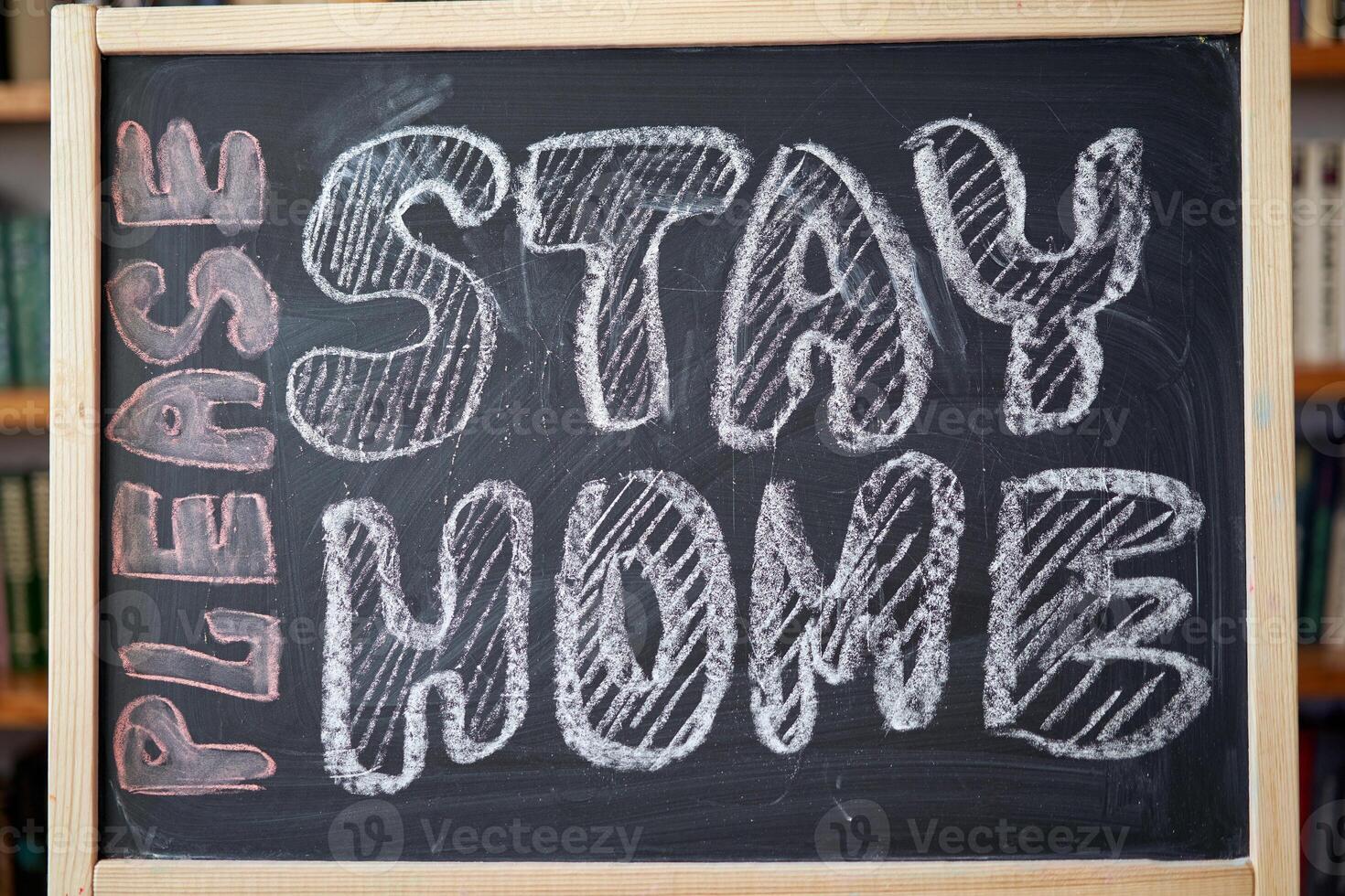 inscription stay at home. Outbreak Warning. written white chalk on blackboard in connection with epidemic of coronavirus worldwide. photo