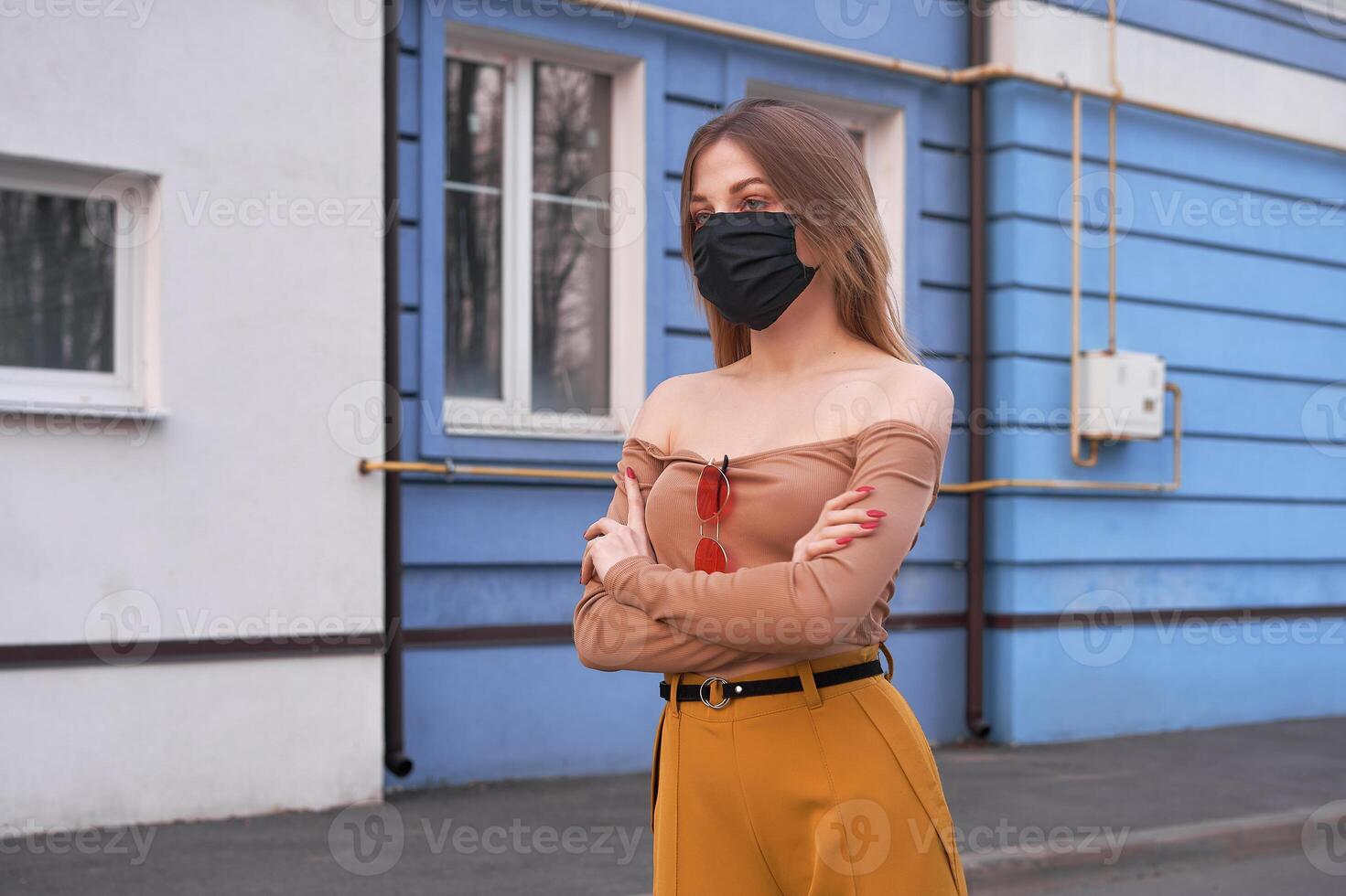 Young Caucasian European girl 20 years old wearing black protective medical mask protection against epidemic coronavirus covid-19 photo