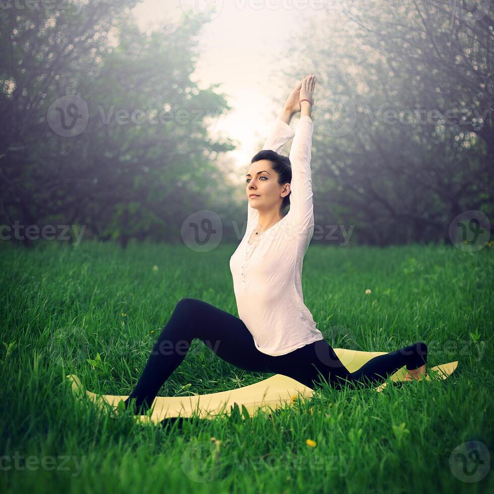 beautiful girl is engaged in yoga in the forest photo