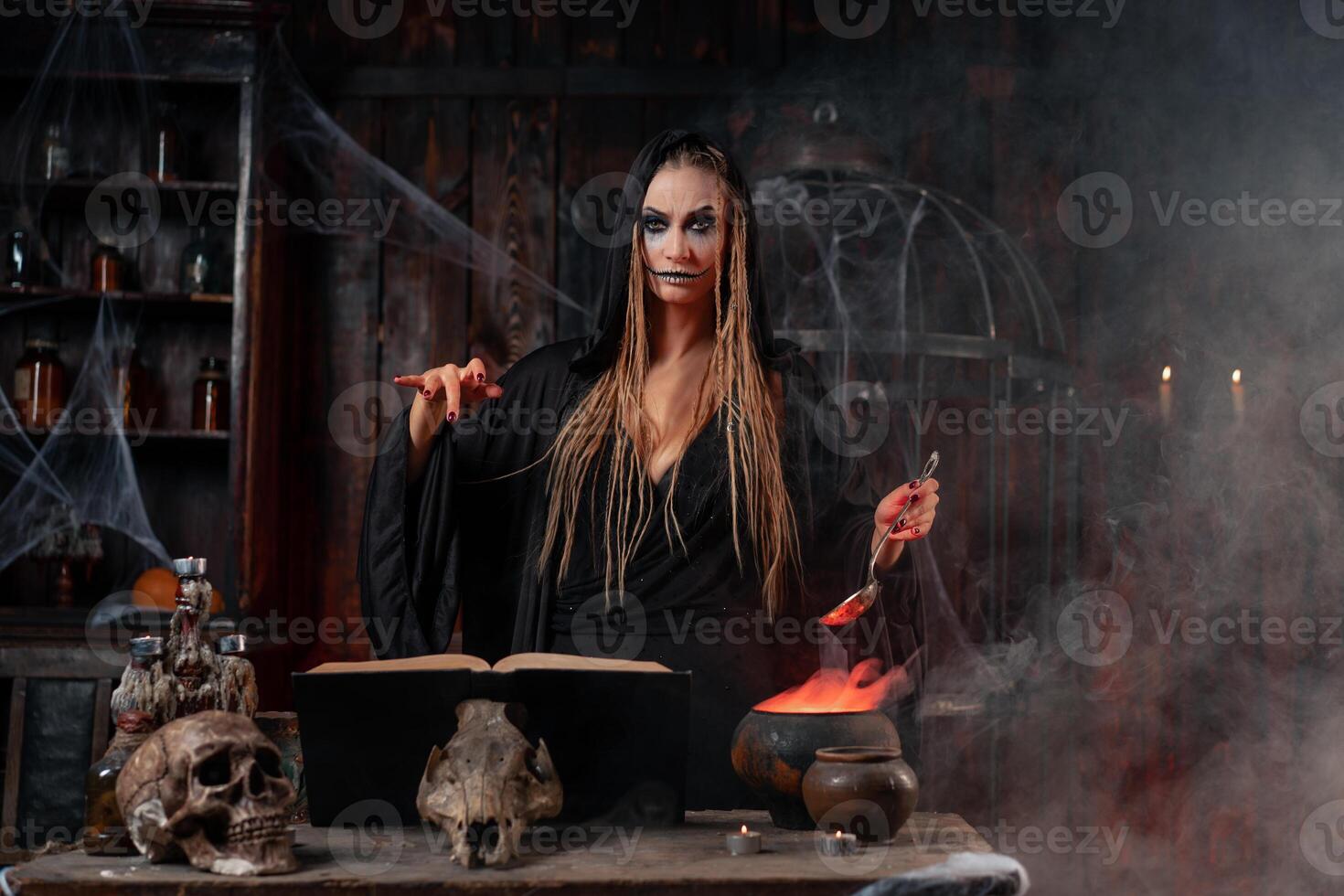 Halloween, witch use magic book and cauldron prepare poison or love potion photo