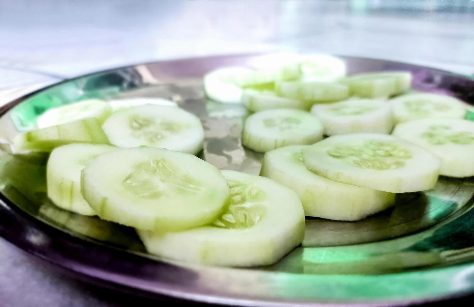 Pieces of cucumber salad on the plate photo