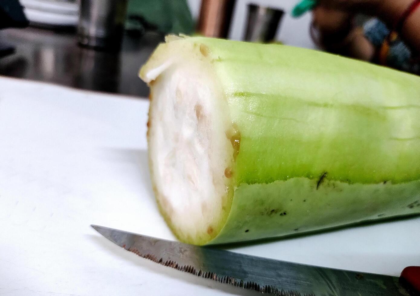 Sliced bottle gourd with Knife on the table photo