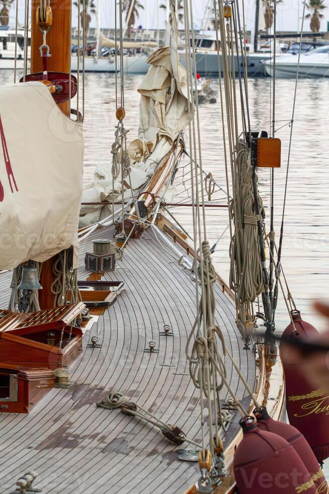 An image shows an old-fashioned yacht docked photo