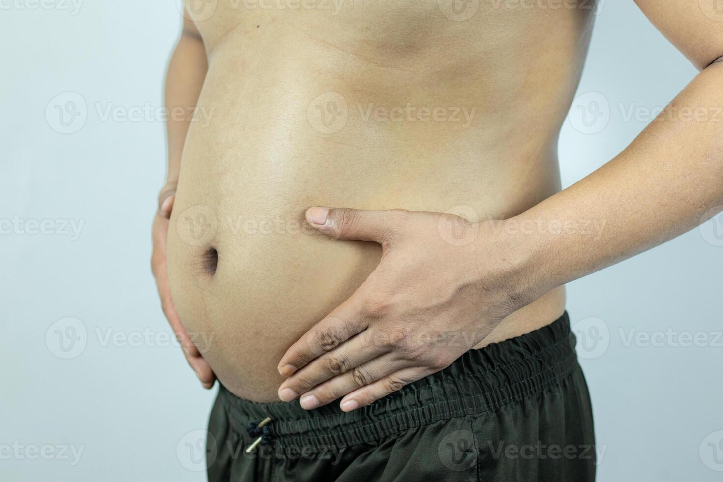 Men with pot bellies or belly fat. Close-up of body parts photo