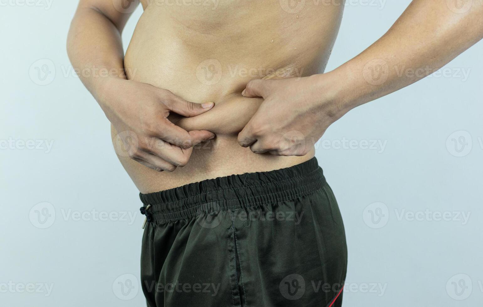 Man touching pot belly or belly fat. Close-up of body parts photo