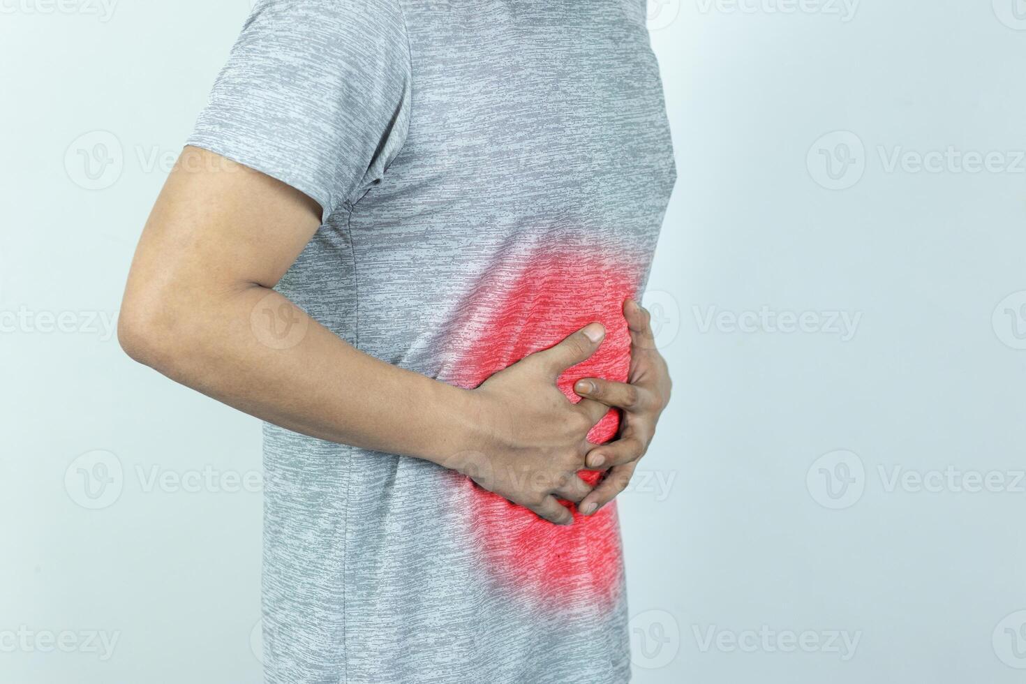 Man suffering with severe stomach pain. Hand of mature guy holding abdomen suffering from ache, diarrhea or indigestion problem. photo