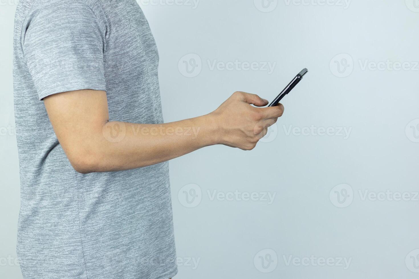 Asian man sending text message on smart phone on white Background photo