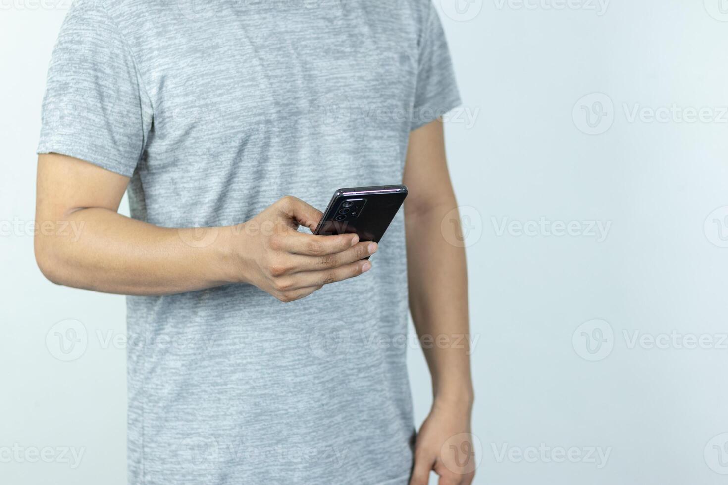 Asian man sending text message on smart phone on white Background photo