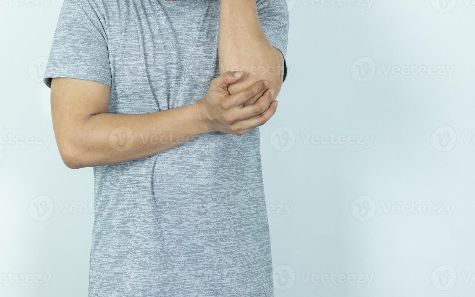 Man suffering from pain in elbow on white background photo