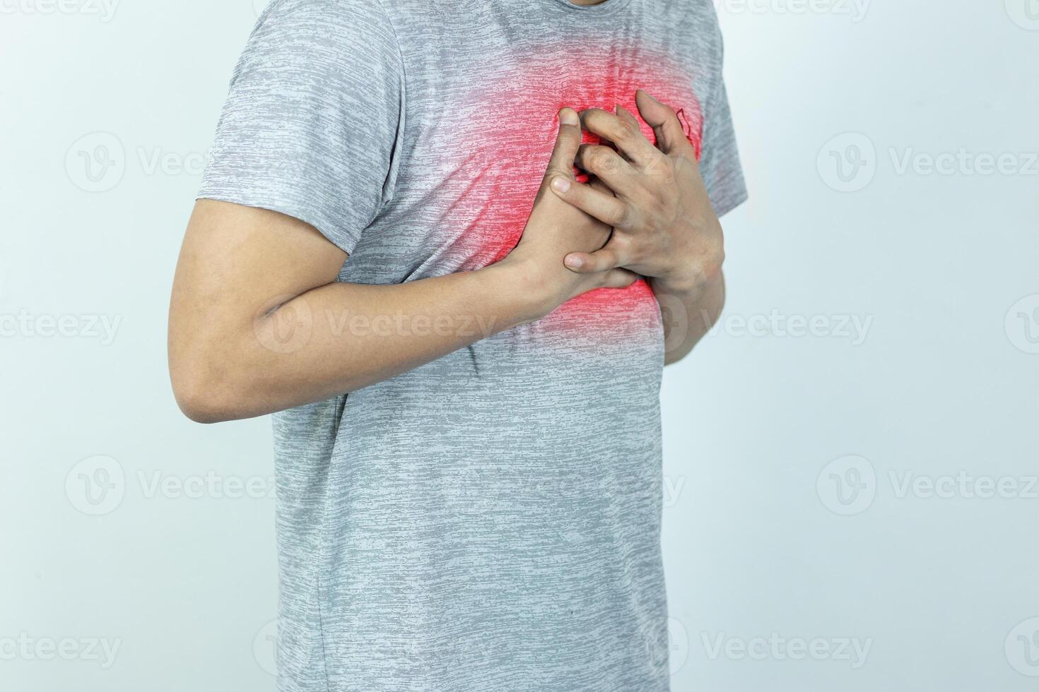 asian man pressing chest with painful expression. Severe heartache, having a heart attack or painful cramps, heart disease. photo