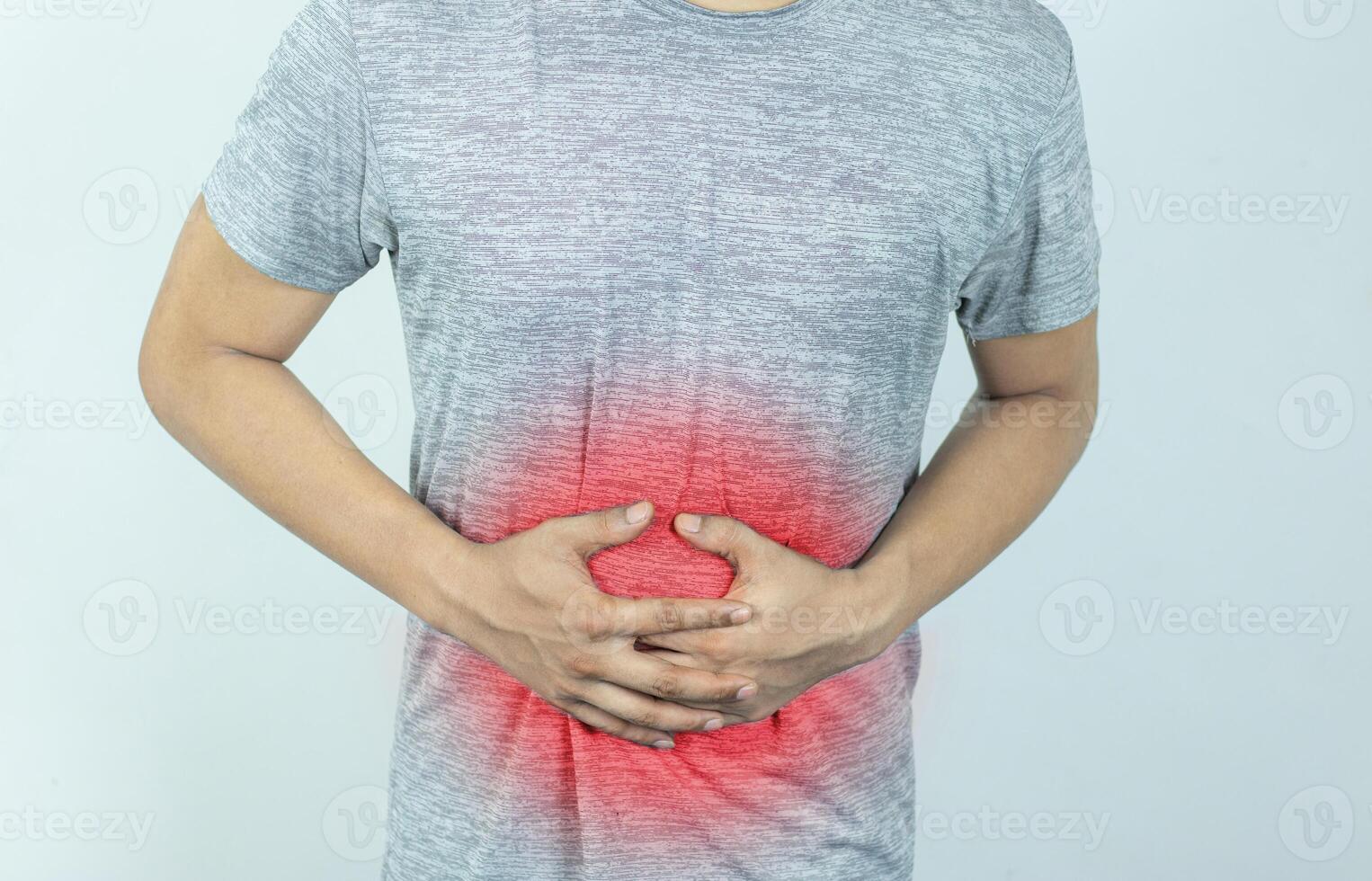 Man suffering with severe stomach pain. Hand of mature guy holding abdomen suffering from ache, diarrhea or indigestion problem. photo