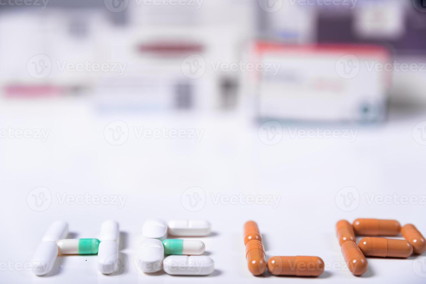 Word HELP made with medical pills and in the background several boxes of medicines. photo