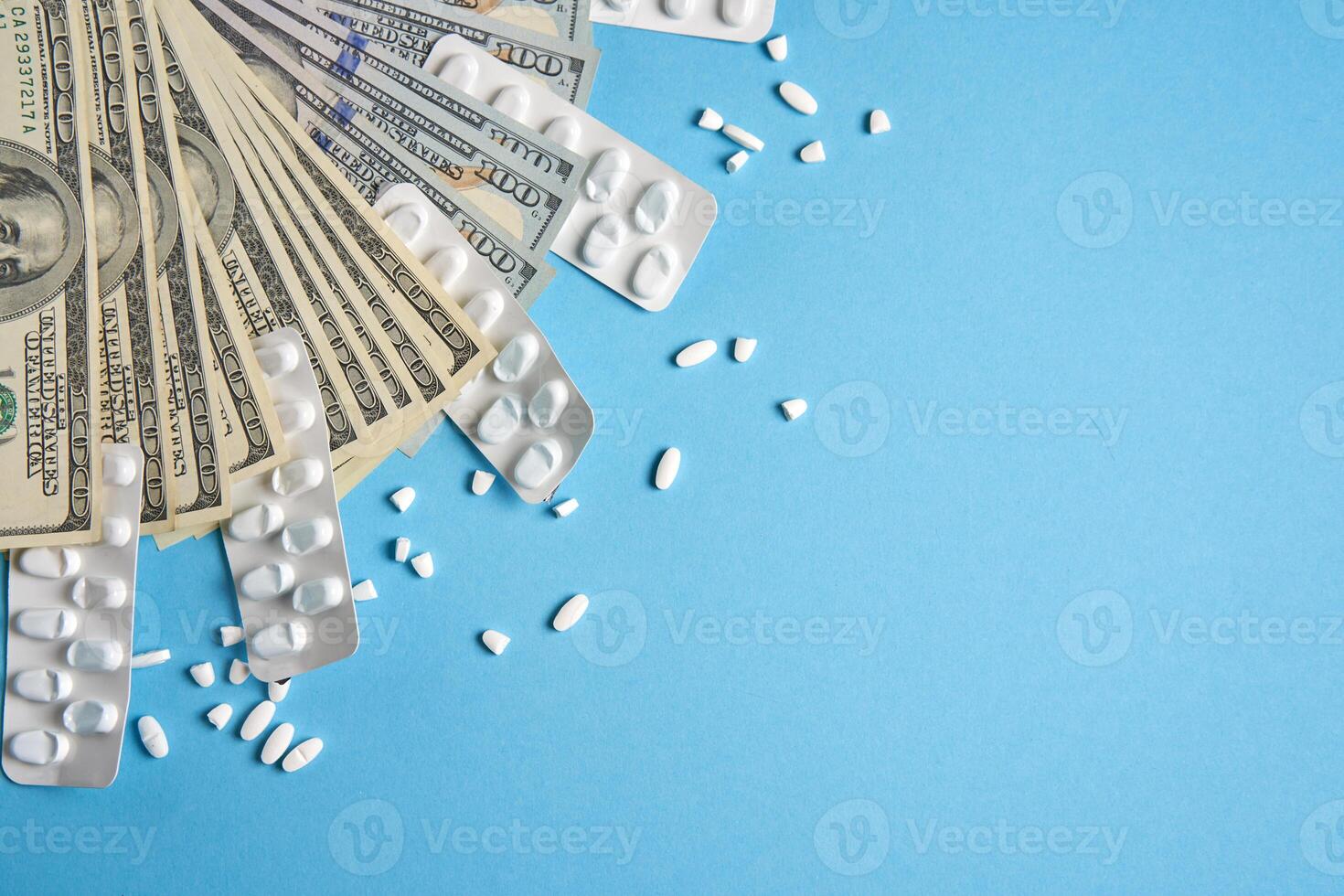 pills empty blisters for drugs individual  and money lie on a blue background photo
