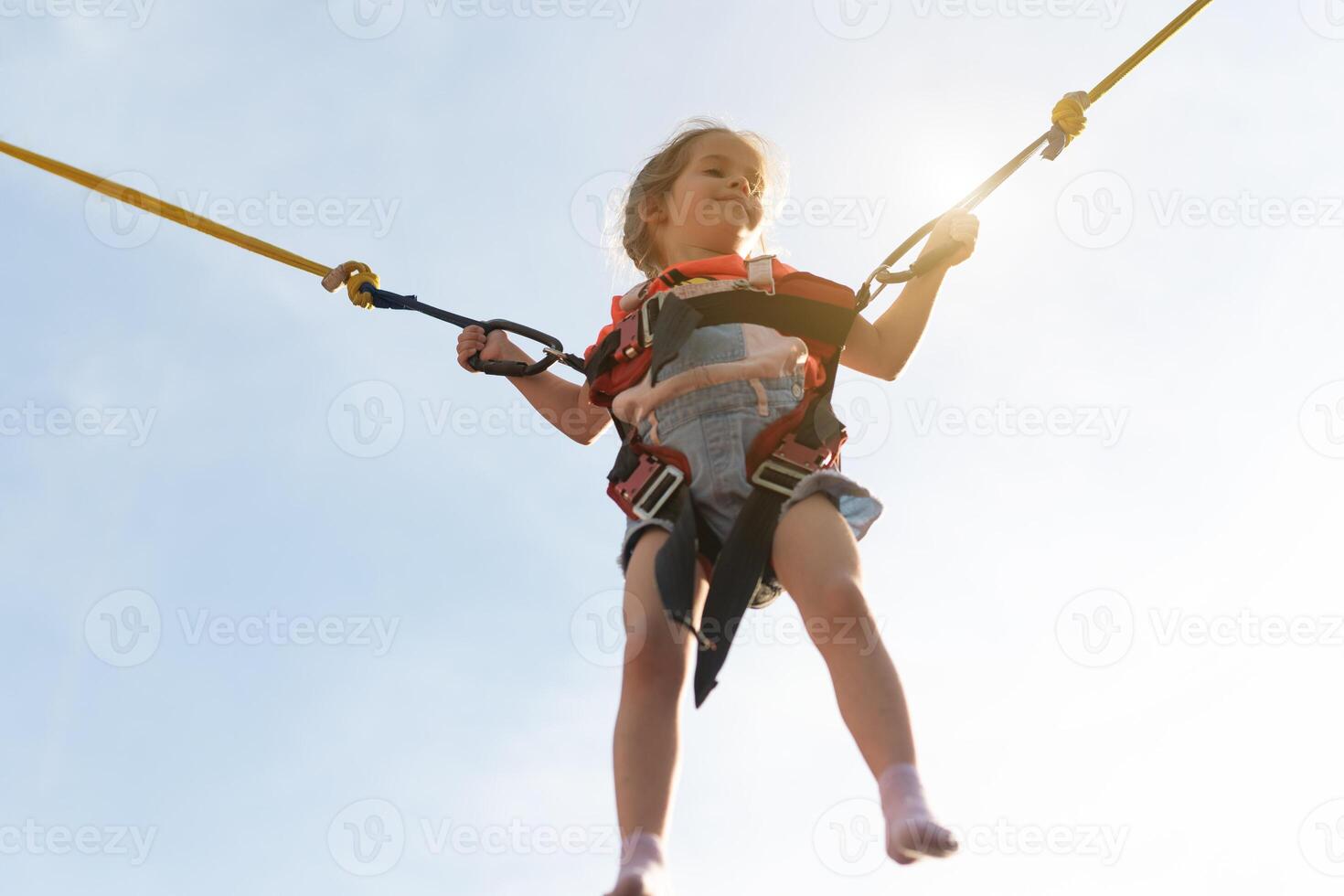 Child jumping child trampoline rubber bands photo