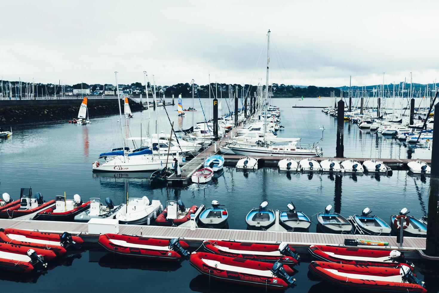 Brest, France 31 May 2018 Panoramic outdoor view of sete marina Many small boats and yachts aligned in the port. Calm water and blue cloudy sky. photo