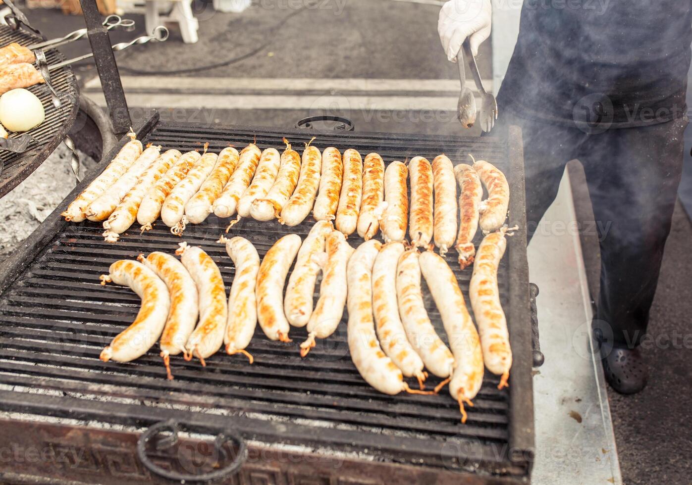 BBQ with fiery sausages on the grill photo