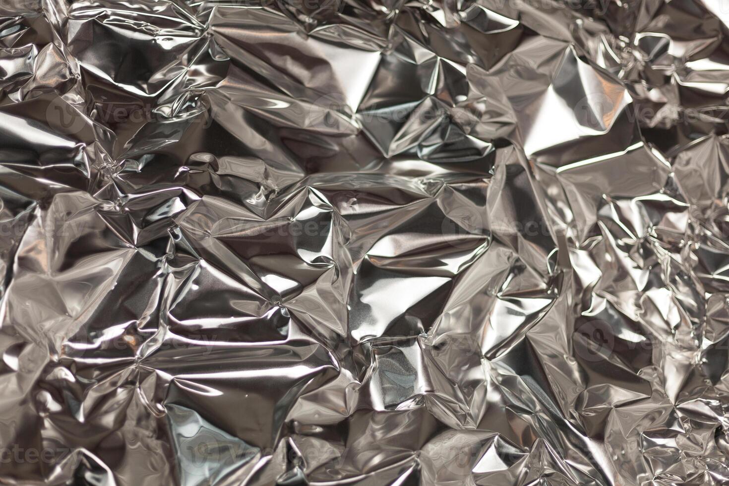 Full frame take of a sheeT of crumpled silver aluminum foil photo