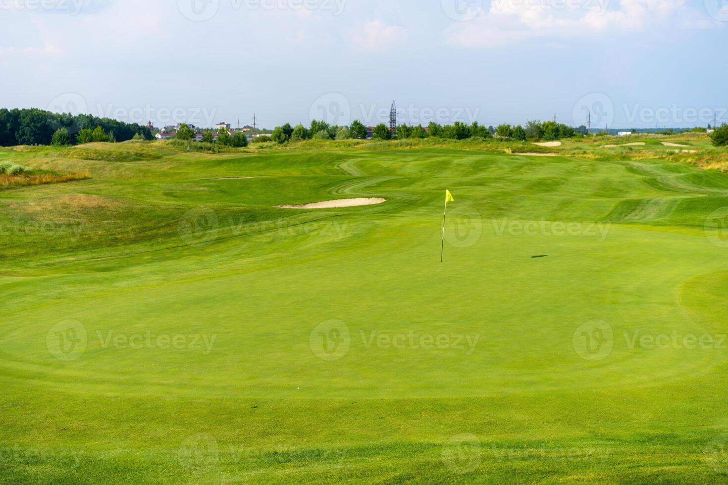 Green grass and woods on a golf field photo