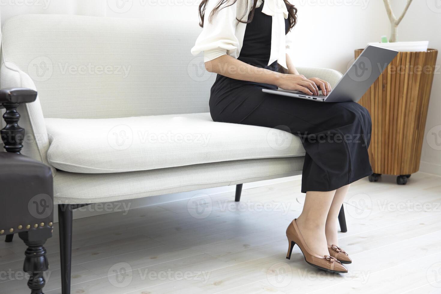 A Japanese woman typing laptop by remote work in the office faceless composition photo