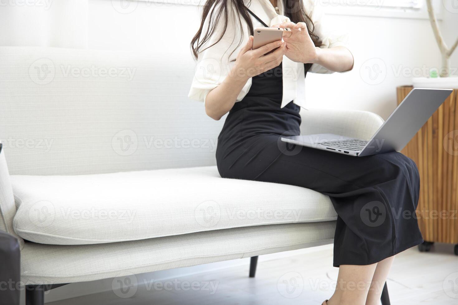 A Japanese woman checking smartphone in the home office faceless composition photo