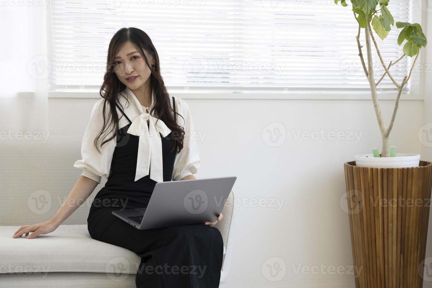 A Japanese woman checking smartphone by remote work in the home office photo