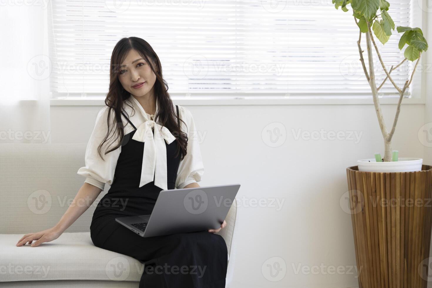 A Japanese woman checking smartphone by remote work in the home office photo