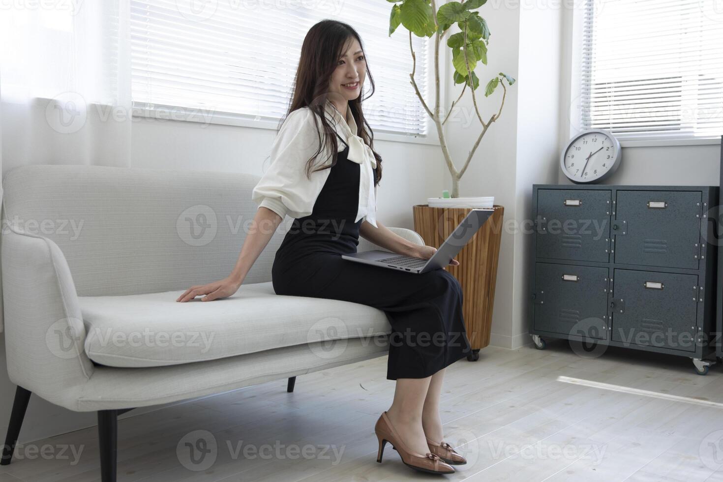 A Japanese woman checking smartphone by remote work in the home office photo
