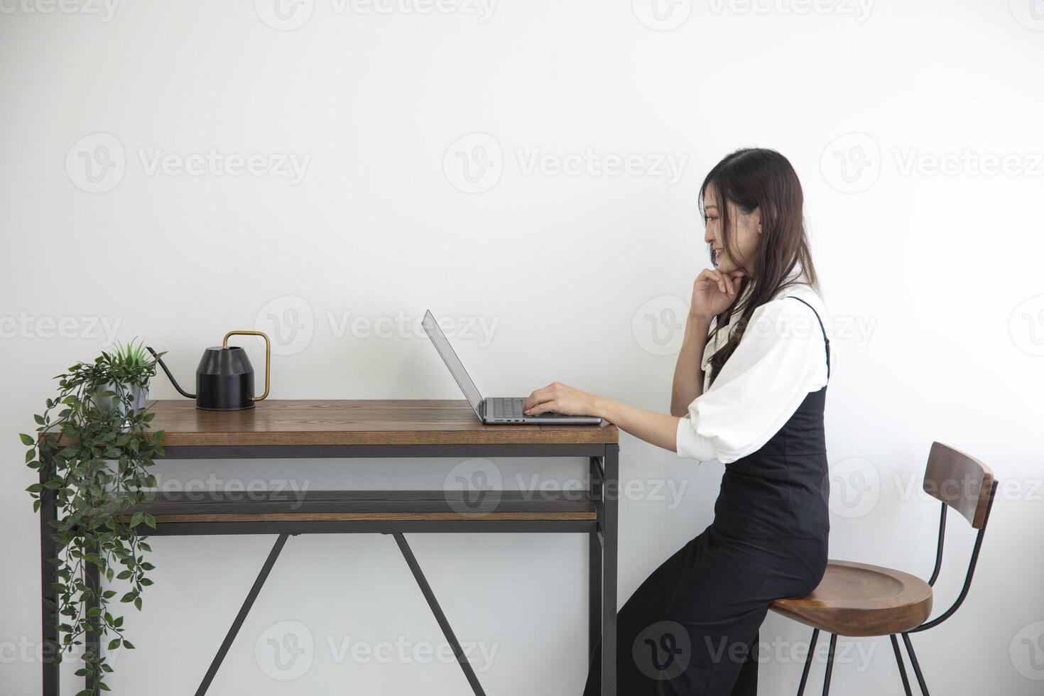 A Japanese woman checking smartphone by remote work in the home office photo