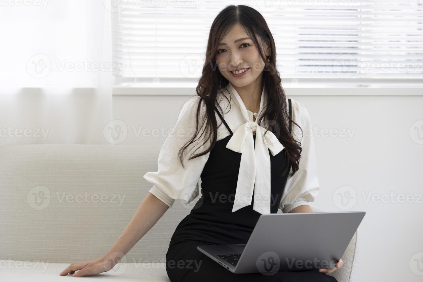 A working Japanese woman by remote work in the home office closeup photo