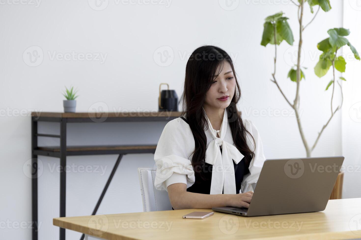A working Japanese woman by remote work in the home office closeup photo