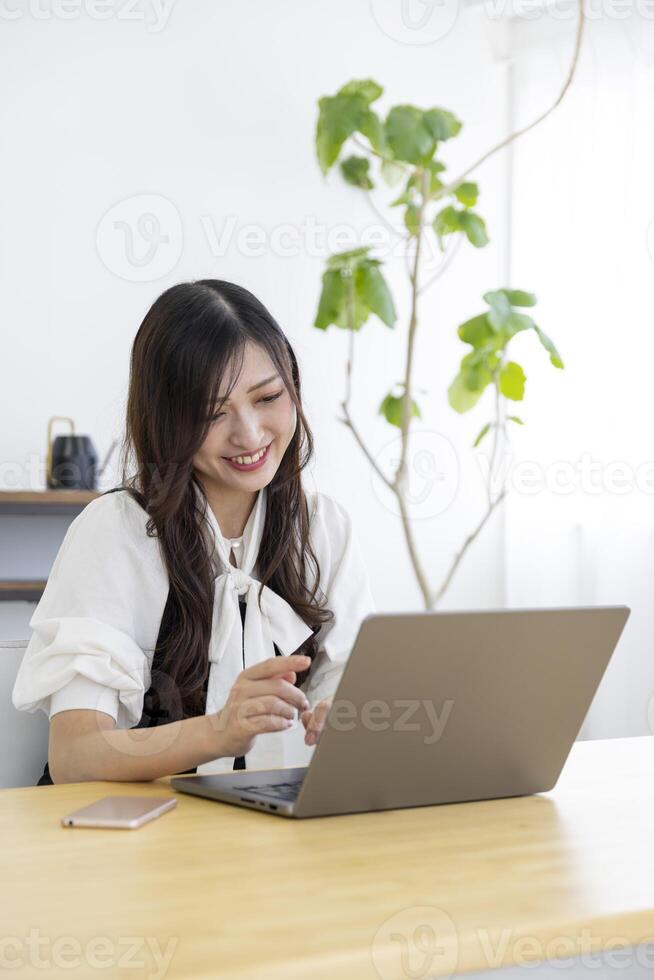 A working Japanese woman by remote work in the home office closeup photo