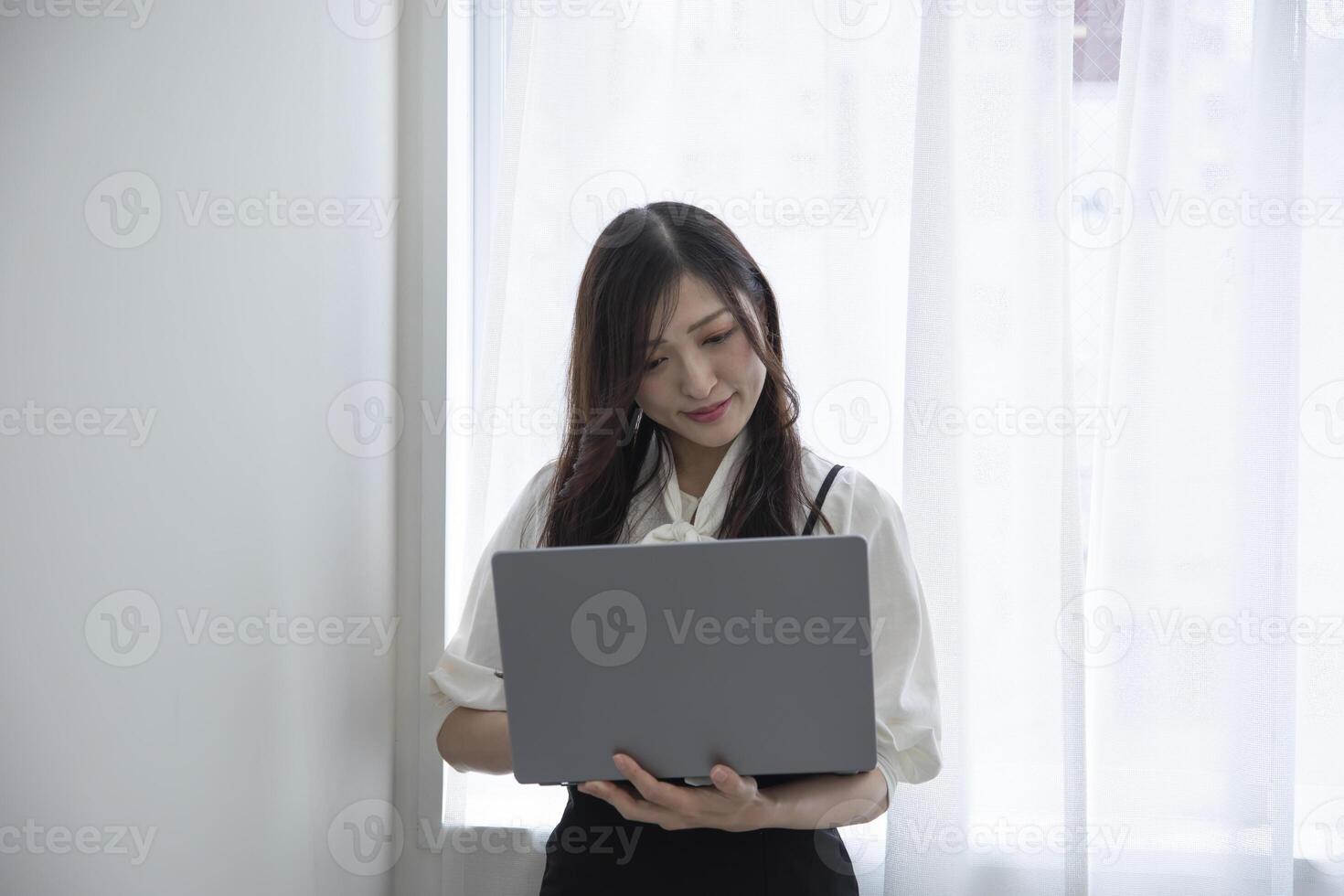 A working Japanese woman by remote work in the home office closeup photo
