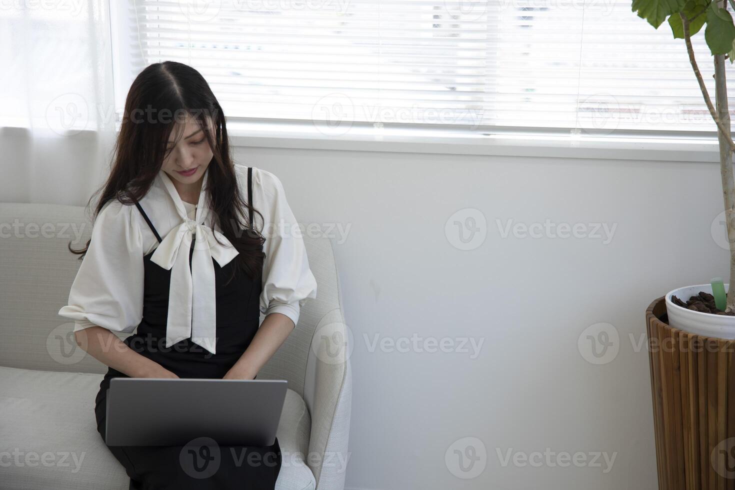 A working Japanese woman by remote work in the home office closeup photo