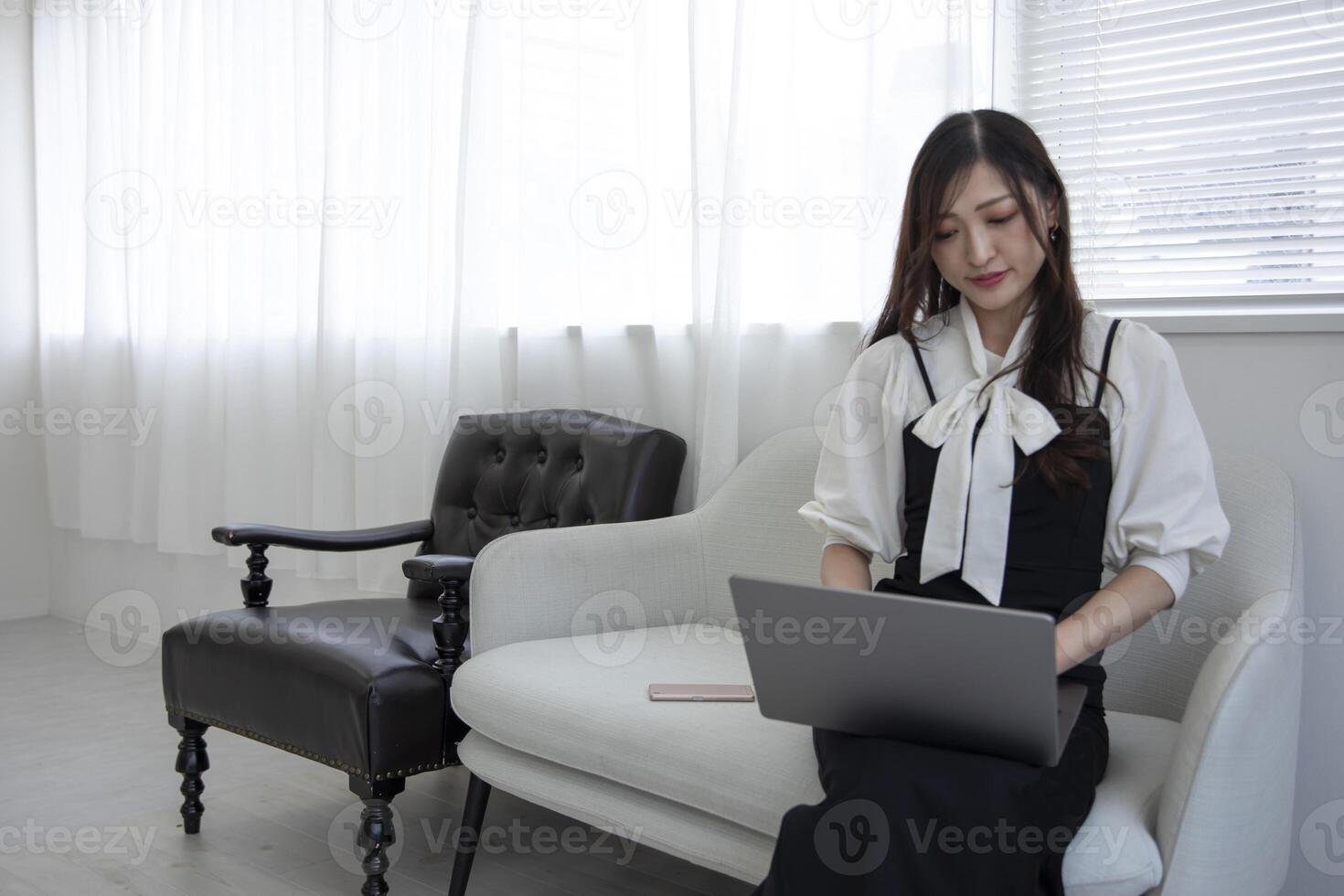 A working Japanese woman by remote work in the home office closeup photo