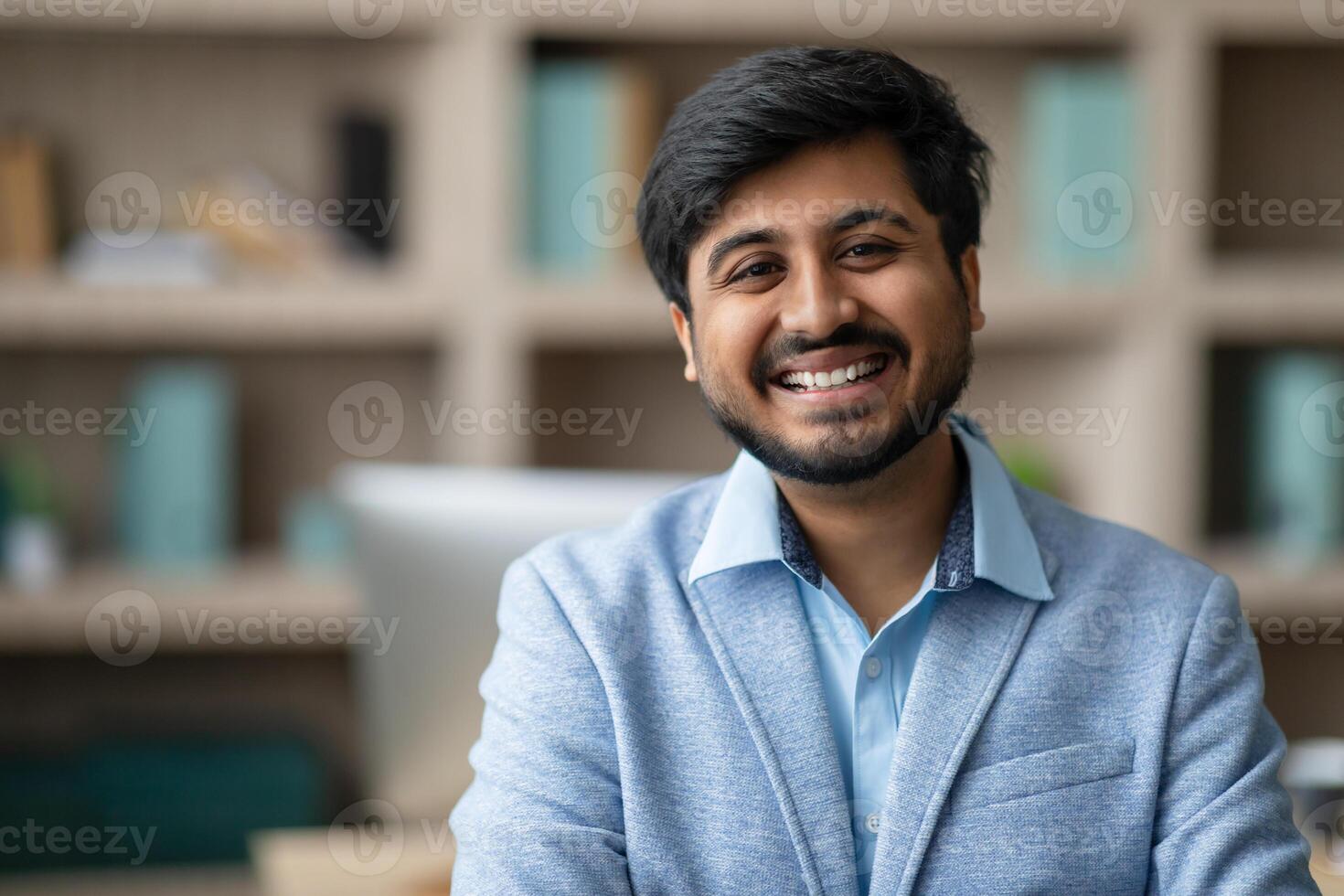 Smiling Bearded Middle Eastern businessman exuding confidence in office photo