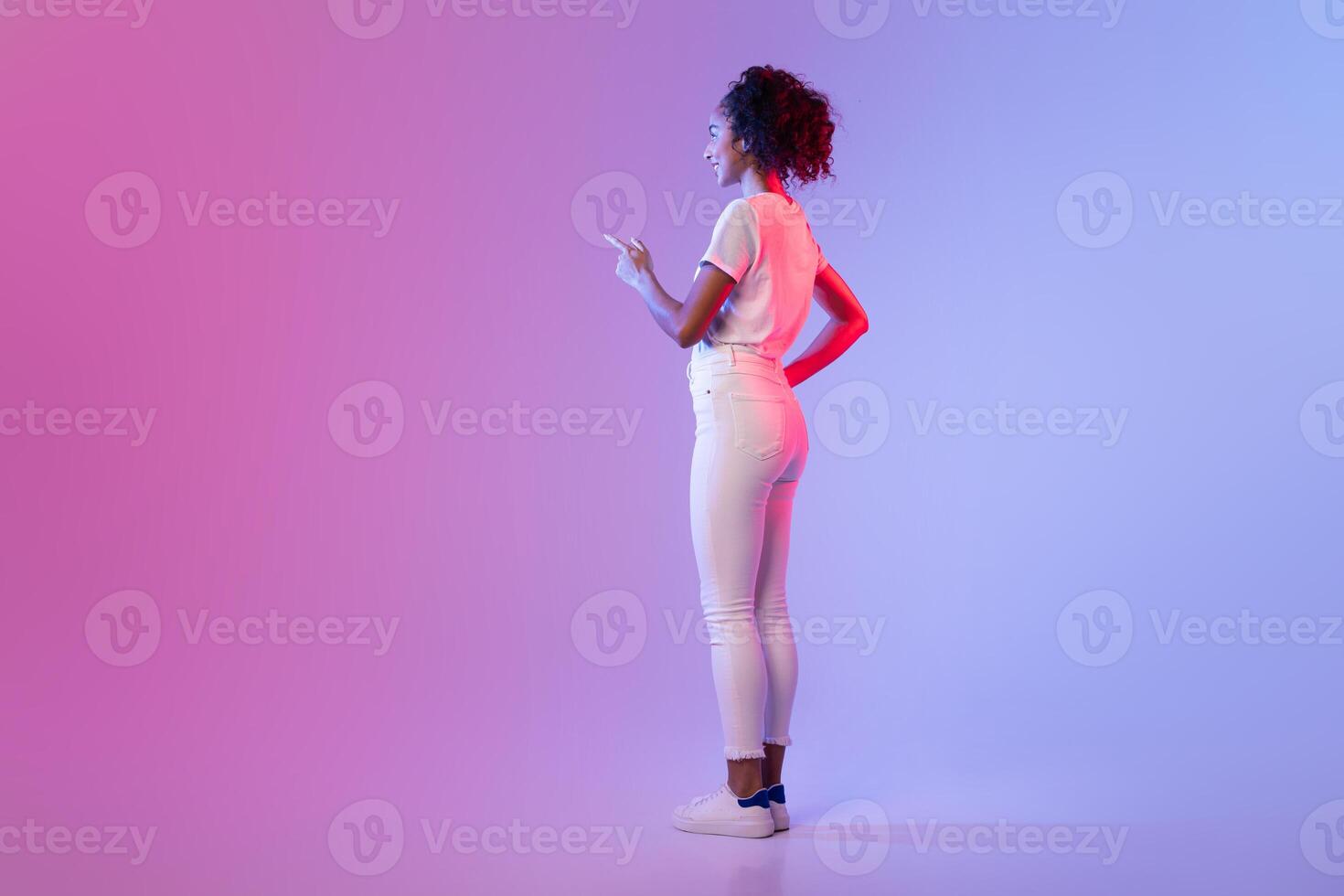 Woman gesturing to blank space on gradient background photo