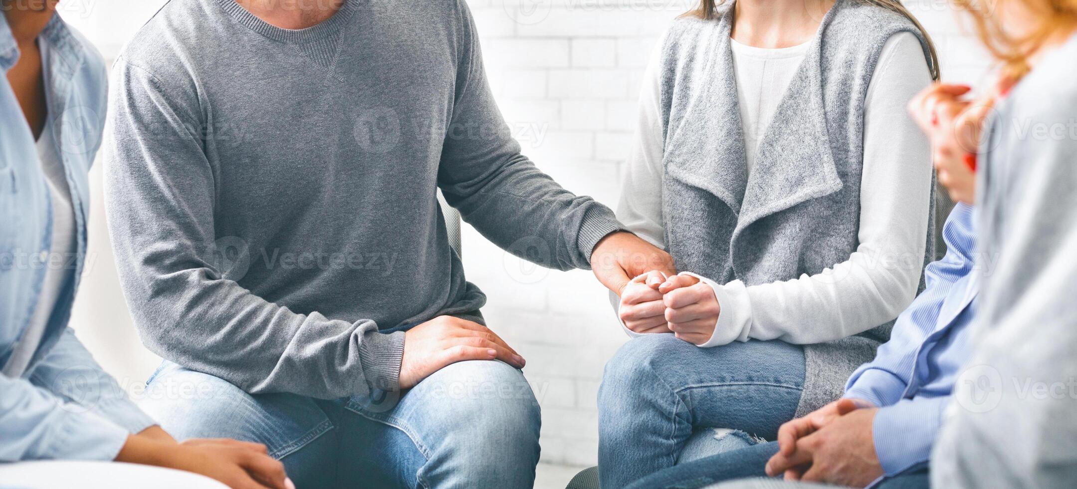 Depressed addicted woman sharing her problems at group meeting photo