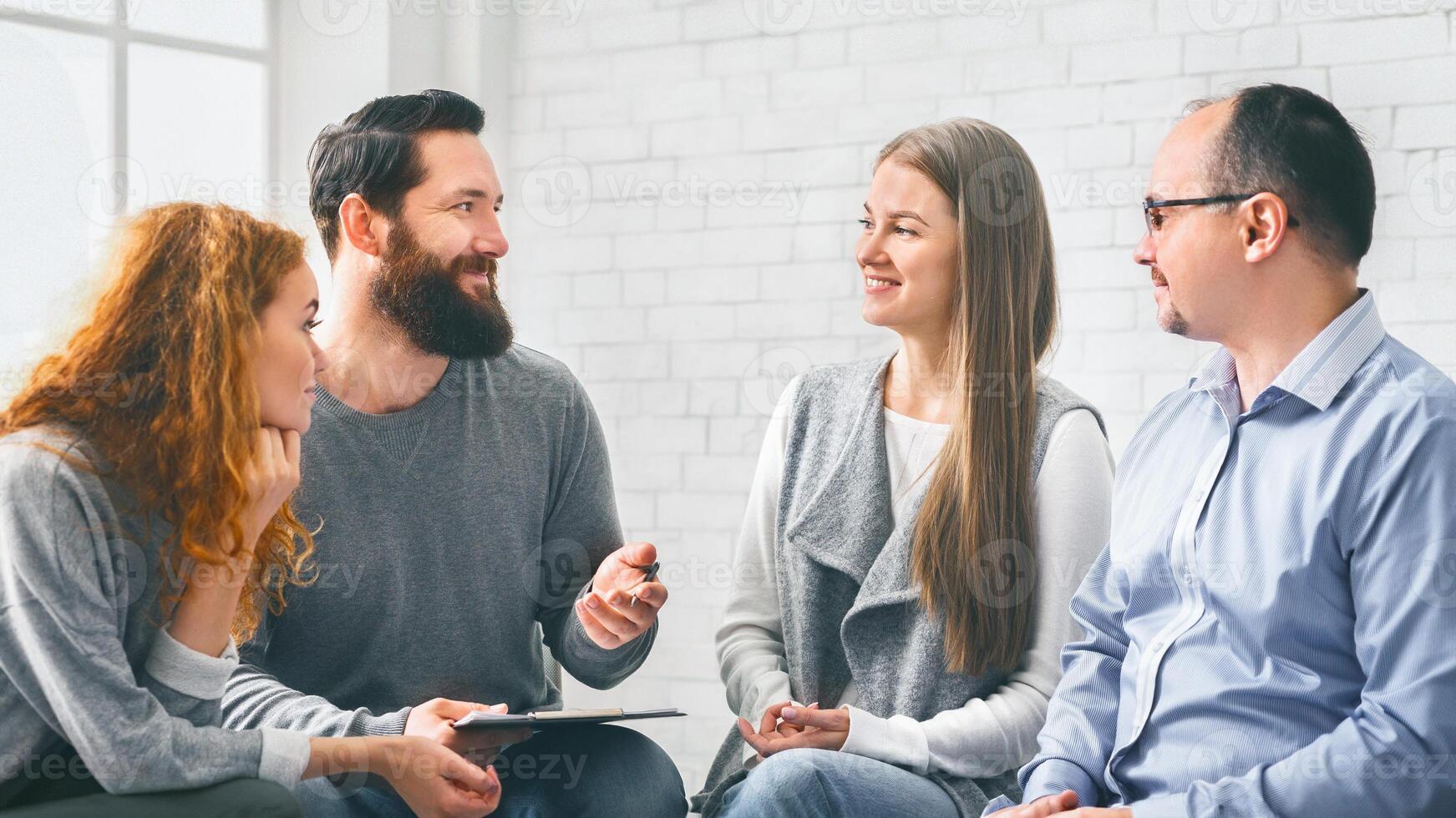 Therapist talking with patients during support group session photo