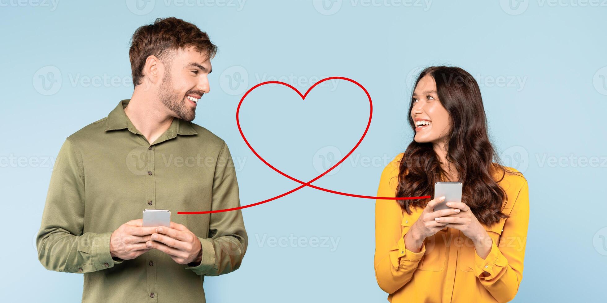 A smiling man in a green shirt and a woman in a yellow top are happily using their smartphones photo