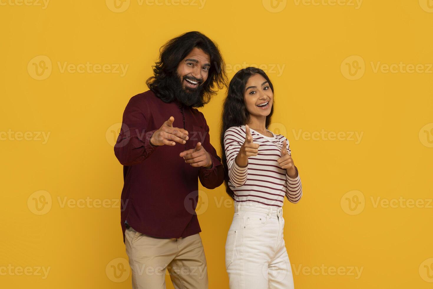 Couple pointing at viewer with excited expressions photo