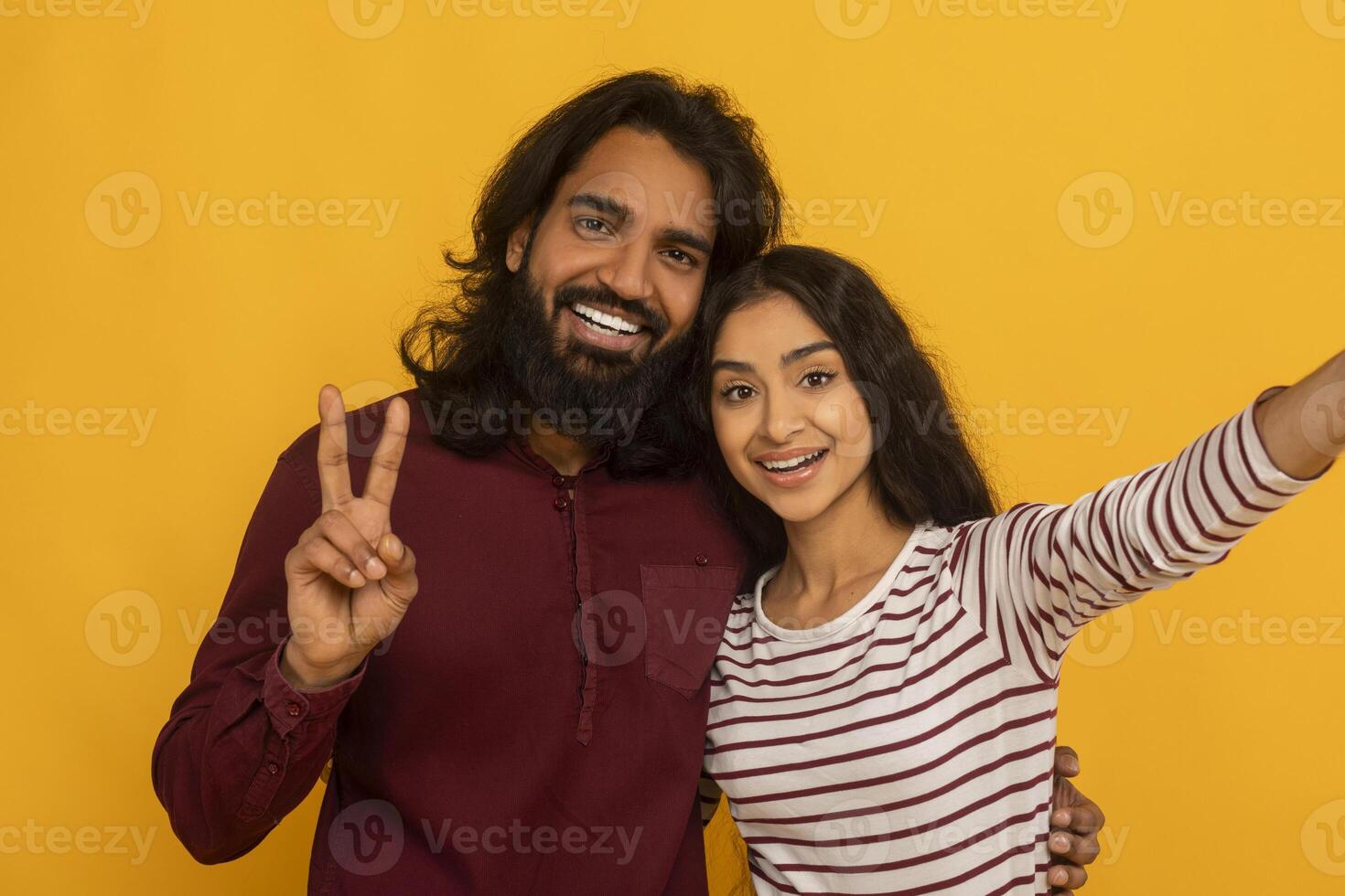Selfie of cheerful couple with peace sign photo