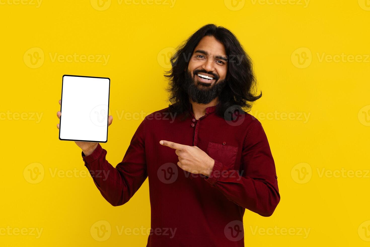 Cool indian man pointing at digital tablet in his hand photo